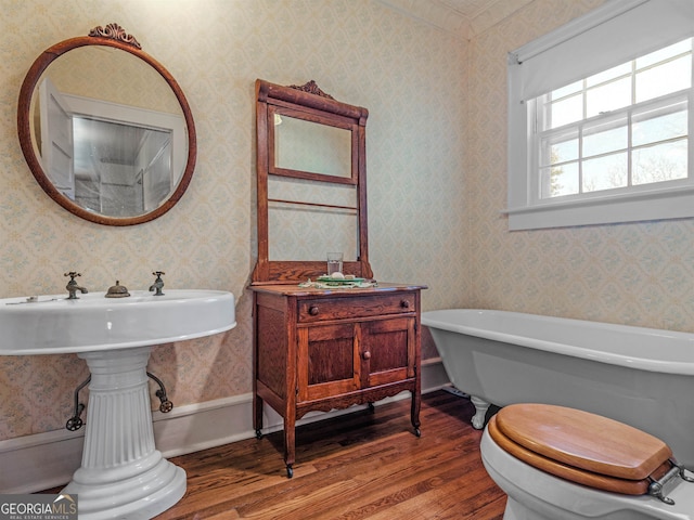 bathroom featuring toilet, a bathtub, and hardwood / wood-style floors