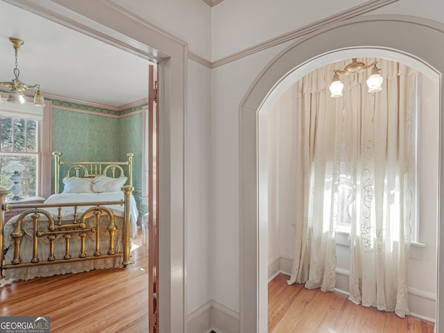 bedroom featuring hardwood / wood-style floors and a notable chandelier