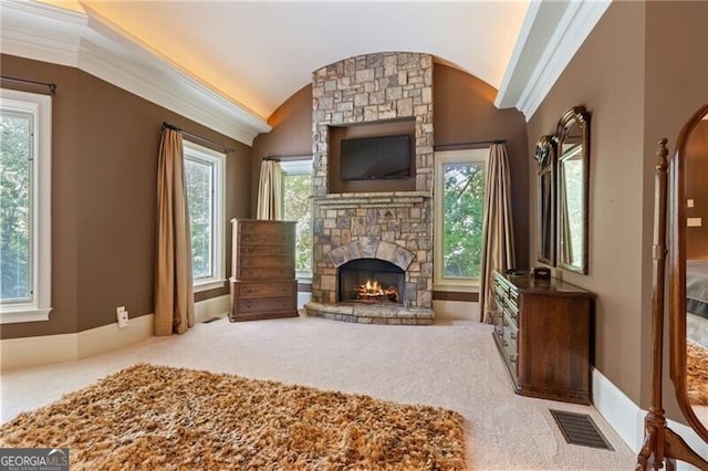 carpeted living room with a fireplace, crown molding, and lofted ceiling