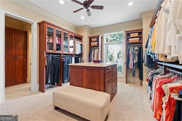 walk in closet featuring light carpet and ceiling fan