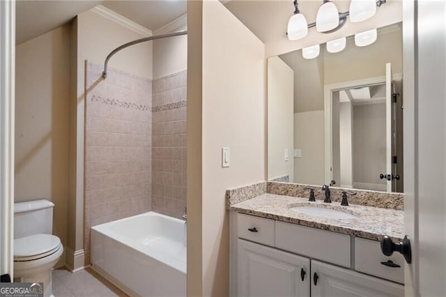 full bathroom with vanity, crown molding, tile patterned flooring, toilet, and tiled shower / bath