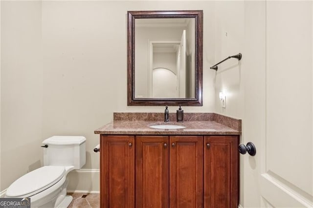 bathroom with vanity, toilet, and tile patterned floors