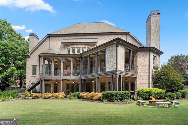 back of house featuring a sunroom and a yard