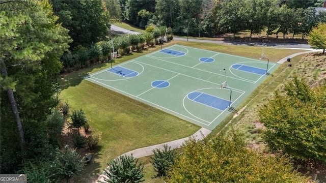 view of sport court featuring a yard