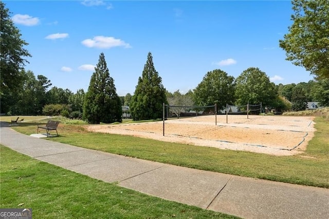 view of home's community featuring a lawn and volleyball court