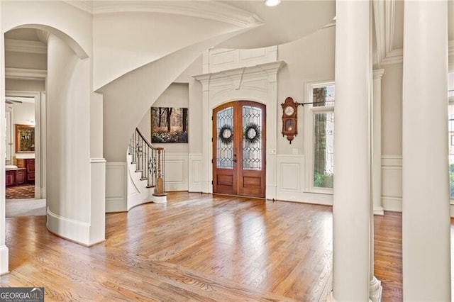 foyer entrance featuring ornamental molding and hardwood / wood-style flooring