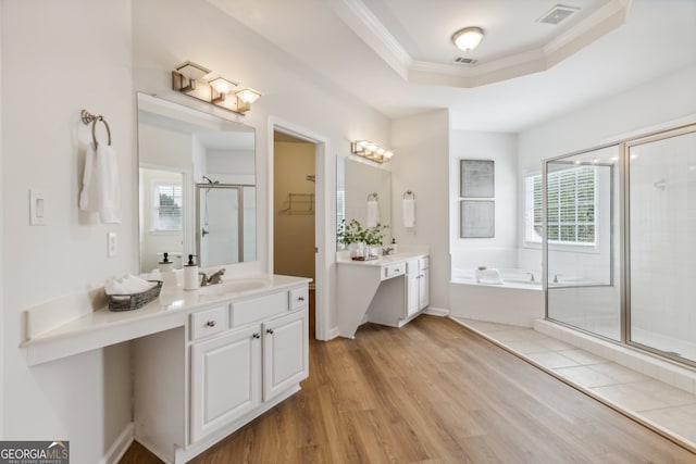 bathroom with crown molding, wood-type flooring, vanity, and separate shower and tub