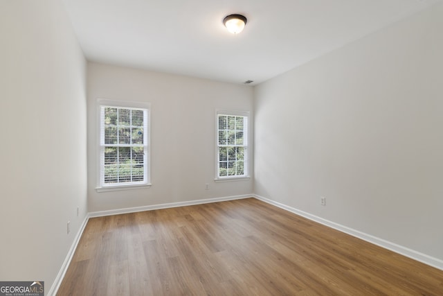 empty room with light hardwood / wood-style floors