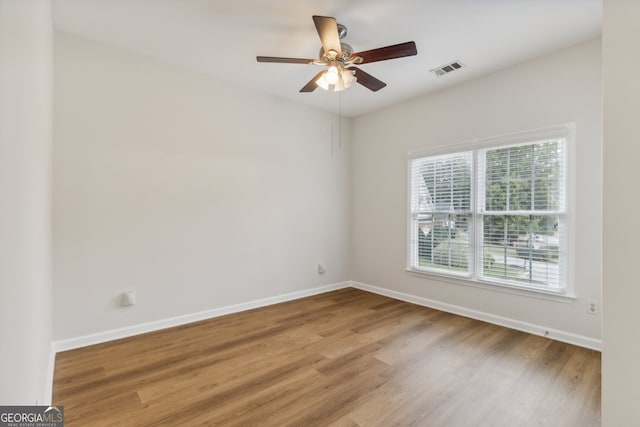 empty room featuring hardwood / wood-style floors and ceiling fan