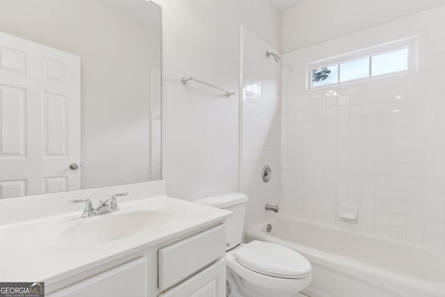 full bathroom with vanity, tiled shower / bath combo, and toilet