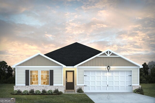 view of front of property with a yard and a garage