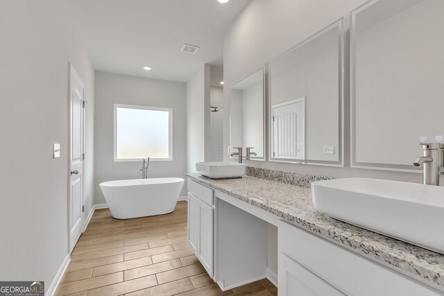 full bathroom with hardwood / wood-style floors, vanity, toilet, and shower / tub combination