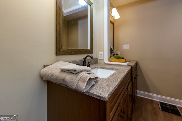 bathroom featuring vanity and hardwood / wood-style flooring