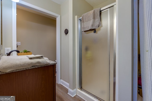 bathroom featuring walk in shower and hardwood / wood-style flooring