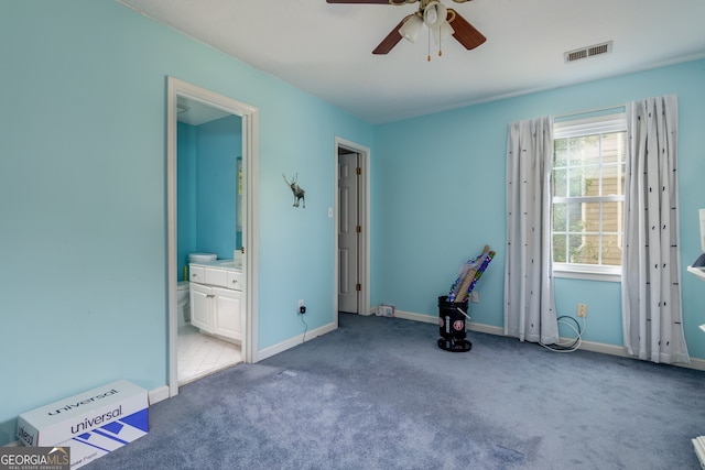 unfurnished bedroom featuring ensuite bath, ceiling fan, and carpet floors