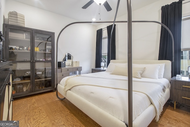 bedroom featuring hardwood / wood-style flooring and ceiling fan