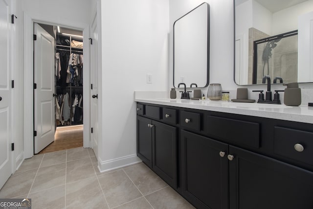 bathroom featuring tile patterned floors, vanity, and an enclosed shower