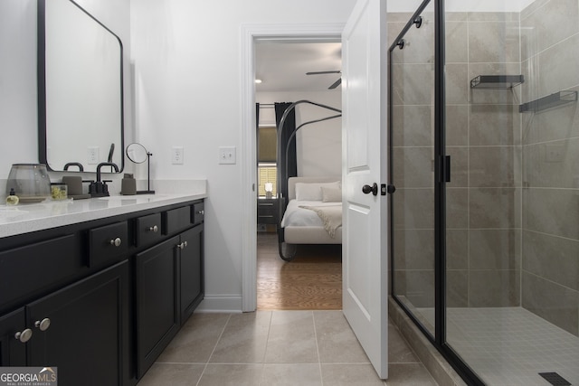 bathroom with tile patterned floors, ceiling fan, vanity, and walk in shower