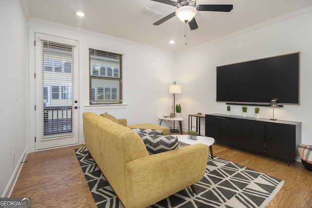 living room with ceiling fan, hardwood / wood-style floors, and crown molding