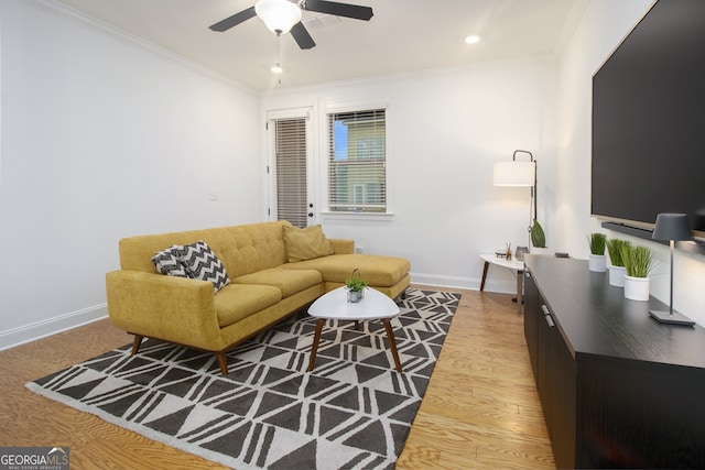 living room featuring ceiling fan, hardwood / wood-style floors, and ornamental molding