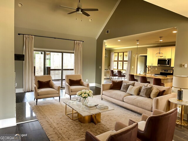 living room featuring dark hardwood / wood-style floors, a high end fireplace, and high vaulted ceiling