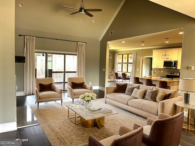 living room with ceiling fan, high vaulted ceiling, crown molding, and dark hardwood / wood-style floors