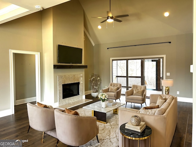 living room with ceiling fan, high vaulted ceiling, a premium fireplace, and dark hardwood / wood-style floors