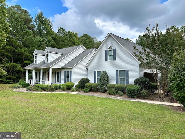 cape cod-style house with a front lawn and covered porch