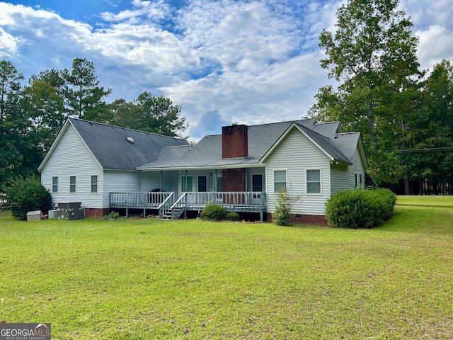 view of front of property with a front yard and a deck