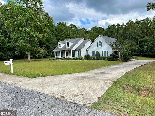 cape cod home with a front lawn