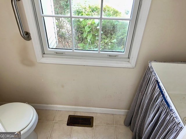 bathroom with tile patterned flooring and toilet