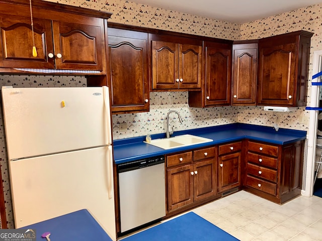 kitchen featuring sink, white fridge, and stainless steel dishwasher