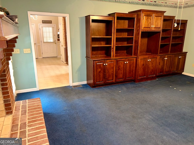 unfurnished living room featuring dark colored carpet