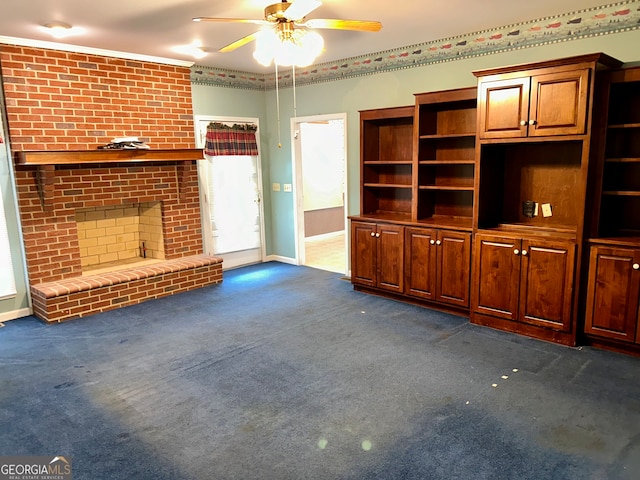 unfurnished living room with dark colored carpet, ceiling fan, and a brick fireplace