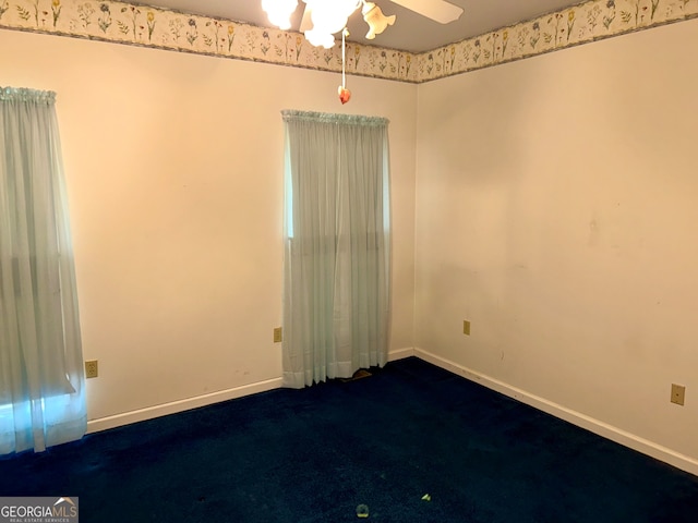 carpeted spare room featuring ceiling fan