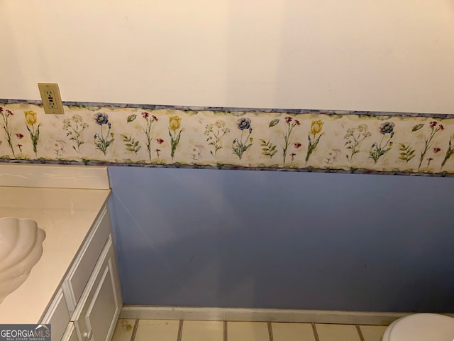 bathroom with vanity, toilet, and tile patterned floors