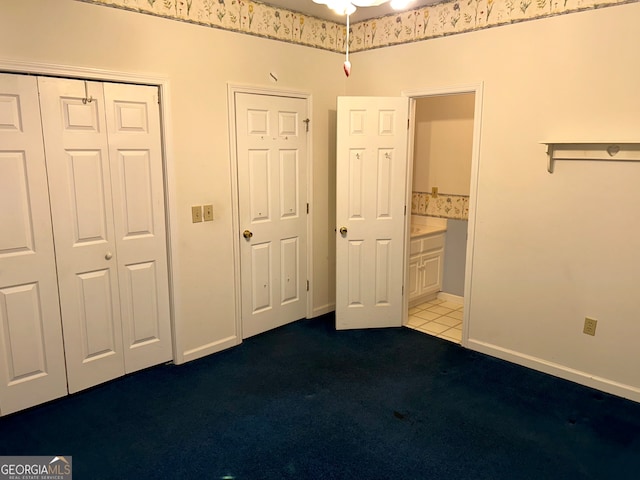 unfurnished bedroom featuring light colored carpet and ensuite bathroom