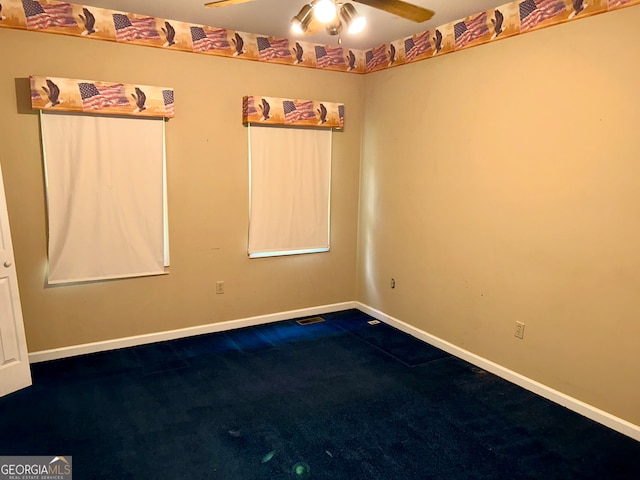 spare room featuring carpet and ceiling fan