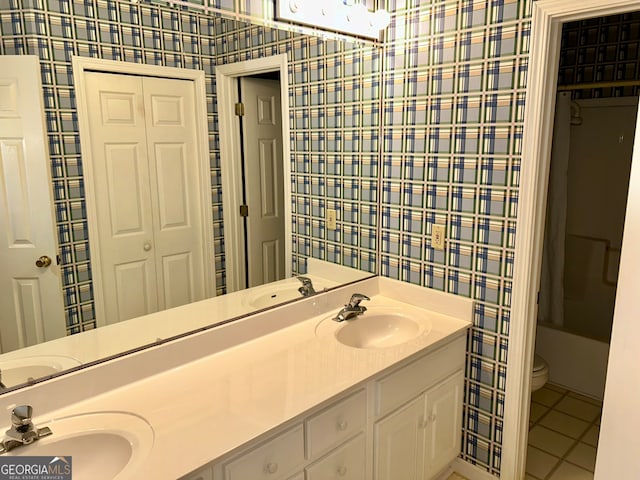 bathroom with tile patterned floors, vanity, and toilet