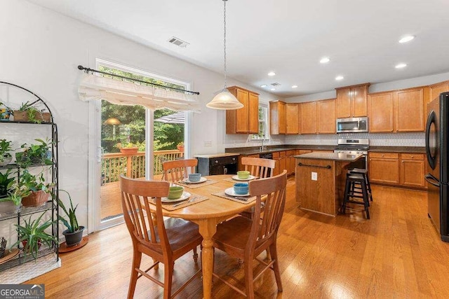 dining area featuring sink and light hardwood / wood-style floors