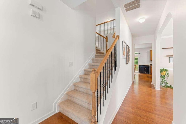 stairway featuring wood-type flooring