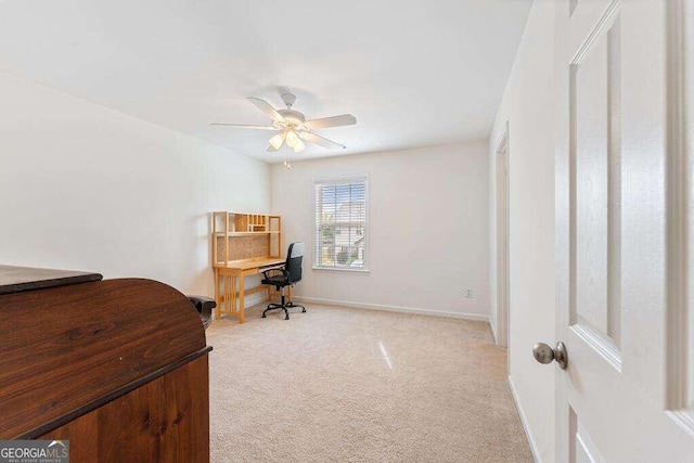 home office featuring light carpet and ceiling fan