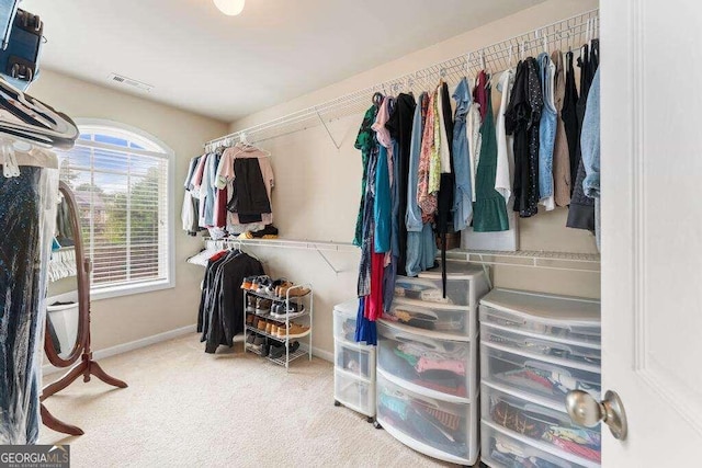 spacious closet featuring light carpet