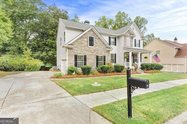 view of front of house with a garage and a front lawn