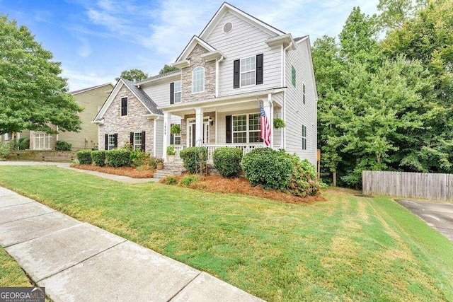 view of front of home with covered porch and a front lawn