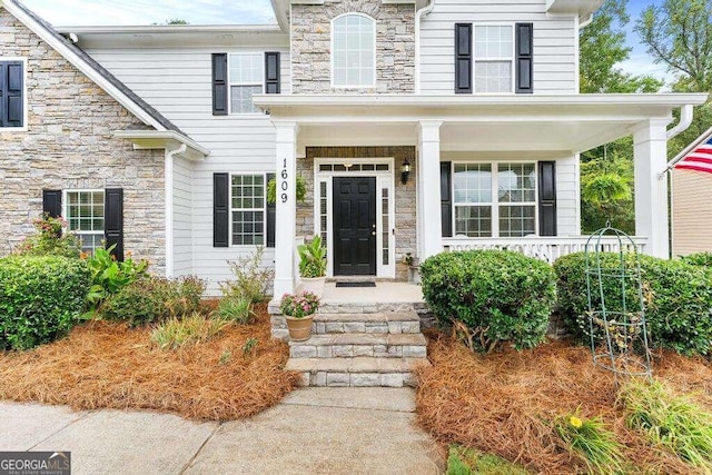 entrance to property featuring covered porch