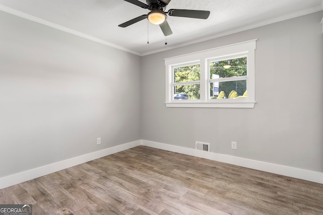 spare room featuring ornamental molding, wood-type flooring, and ceiling fan