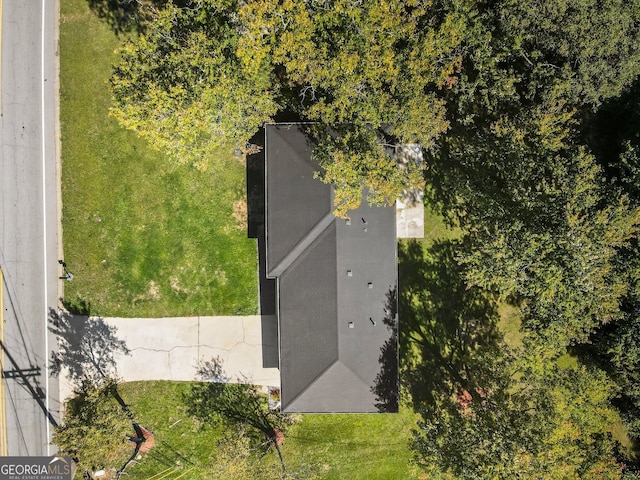 back of house with central AC unit and a lawn