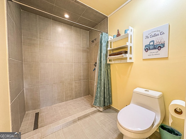 bathroom with tile patterned flooring, a shower with curtain, and toilet