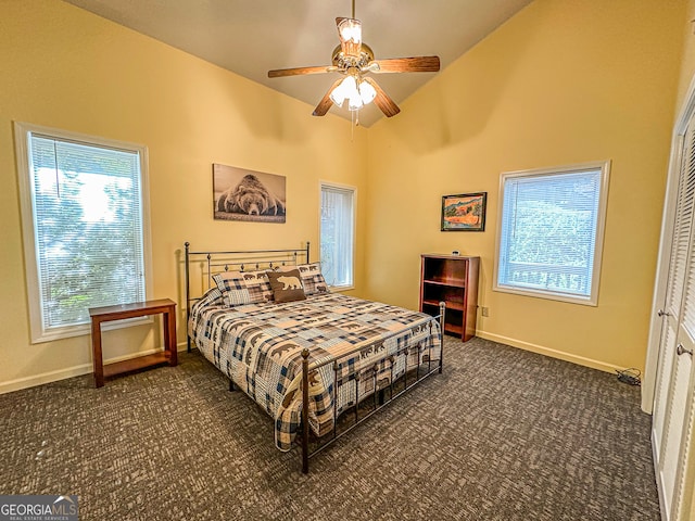 carpeted bedroom featuring ceiling fan, a closet, and high vaulted ceiling